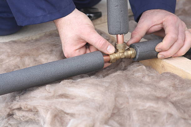 Plumber working with copper water pipes. Aluminum – Stainless Steel Jacket